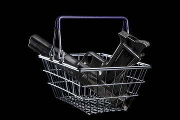 Pistol in a shopping cart. Isolated on black background. With copy space text. Studio Shot.