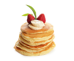 Tasty pancakes decorated with banana slices, strawberry and mint on white background