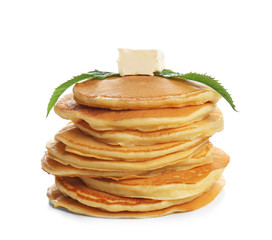 Tasty pancakes with mint and piece of butter on white background