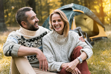 Joyful man embracing woman with love outdoors