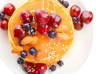 Plate with tasty pancakes and berries on white background, closeup