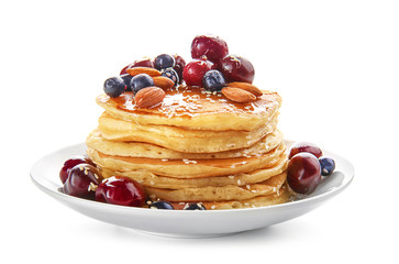 Plate with tasty pancakes and berries on white background