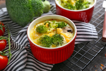 Ramekin with broccoli casserole on table
