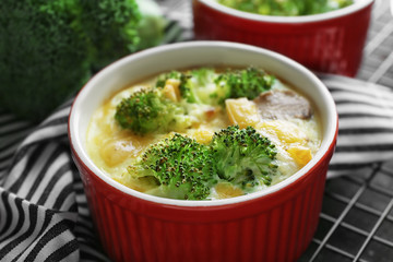 Ramekin with broccoli casserole on table