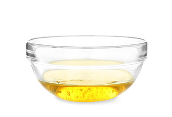 Glass bowl with cooking oil on white background
