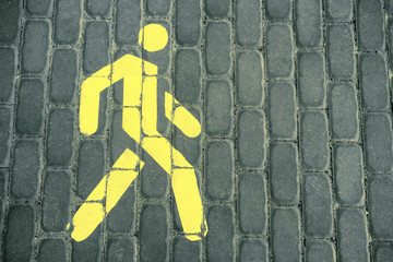 Pedestrian sign. The pedestrian road. The sign is yellow.