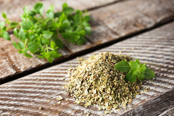 Heap of dried oregano on wooden table