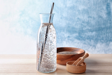 Bottle of water with chia seeds on table