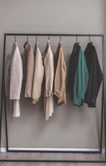 Coats on racks in wardrobe