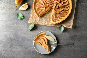 Composition with tasty pear tart on table