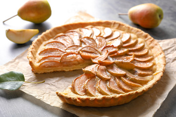 Tasty homemade pear tart on table