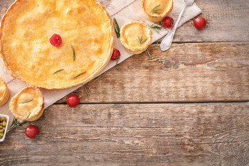 Composition with delicious meat pie on wooden table