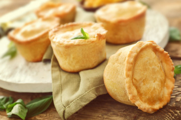 Delicious little meat pies on table