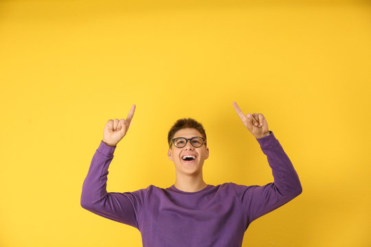 Emotional Teenager Boy In Casual Clothes On Color Background