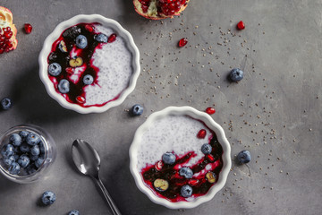 Bowls with delicious chia seed pudding on table