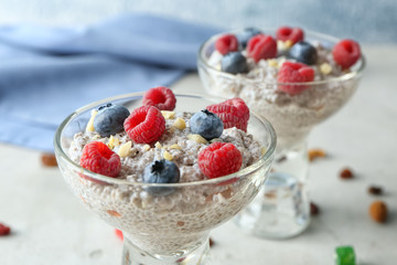 Glass dessert bowls with delicious chia seed pudding on table