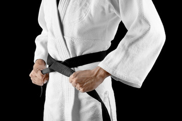 Male karate instructor on dark background