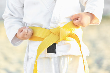 Little child in karategi outdoors, closeup