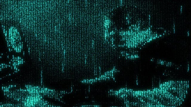 Hacker working on the computer, the code reflect his face in a dark office room