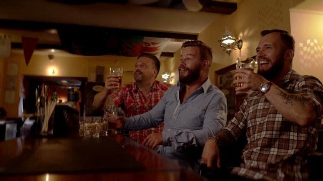 Good old friends watching sports in a pub
