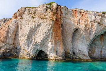 Fototapeta na wymiar Famous Blue Caves and amazing rocks near Skinari Cape. Zakynthos Island, Greece.