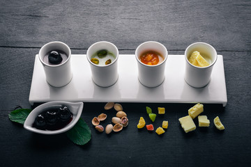 Dessert. Pistachios, dried fruits, cherries and chocolate. Top view. Free space for text. On a wooden background.