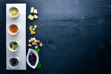 Dessert. Pistachios, dried fruits, cherries and chocolate. Top view. Free space for text. On a wooden background.
