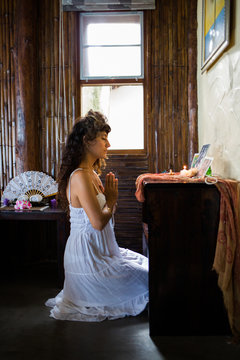 Woman Praying in Front of the Altar