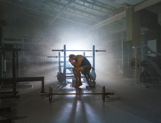 The depressed sportsman sit in the sport center