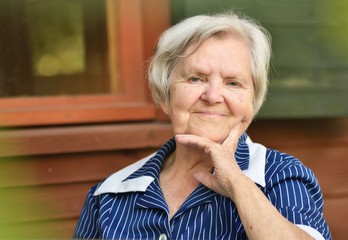 Senior woman on the veranda of his home.