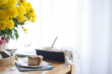 dinner for the family. yellow flowers on the table. table near the window