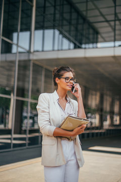 Series of a business woman in the city. Beautiful brunette sitting in coffee shop and working on com
