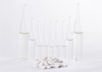 Pills and ampoules with solution isolated on white background