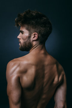 Muscular Shirtless Man in Dark Background