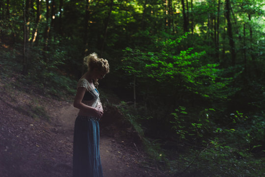 Pregnant woman in the forest