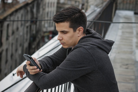 Young male model using his phone