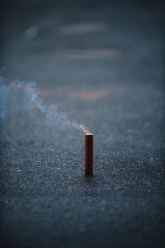 Firecracker with burning fuze