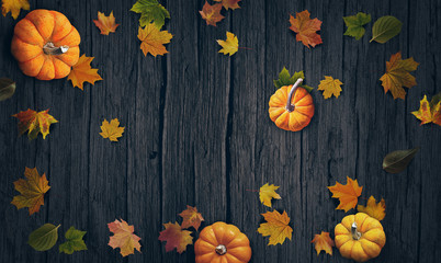 Pumpkins and autumn leaves top view background