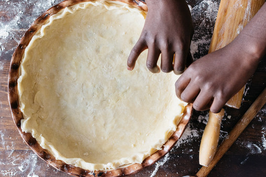 African American child's hands shaping a pie