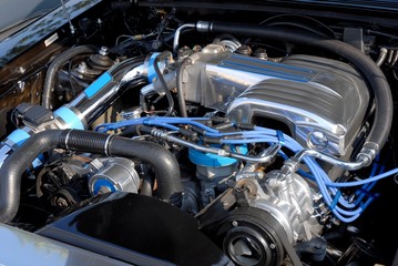closeup of a high performance car engine with blue accent 
