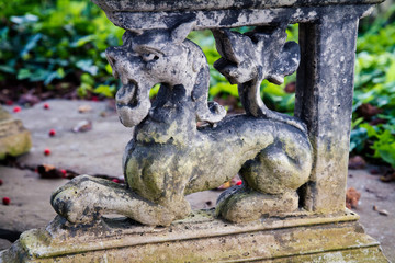 Fototapeta na wymiar Stone decoration of a lion on a garden patio