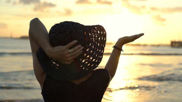 Woman enjoying the sunset on the tropical island, steadycam shot
