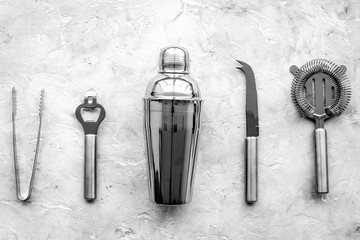 Bar tools for making cocktails on grey stone background top view