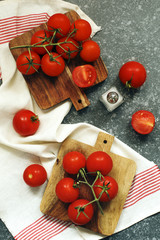Fresh tomatoes on wooden chopping board