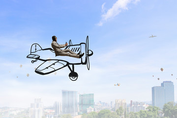 Aviator in drawn airplane. Mixed media