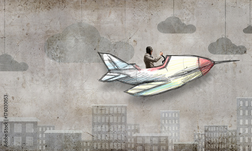 Aviator in drawn airplane. Mixed media