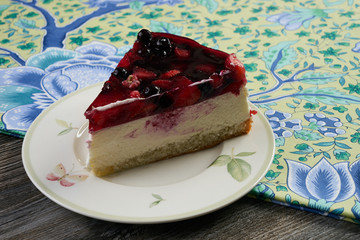 Slice of delicious tasty cheesecake with berry