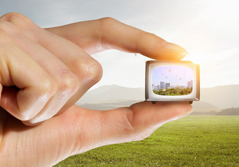 Old tv in hand. Mixed media