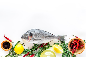 Preparing dorado with spices rosemary, pepper, chili, lemon. White background top view copyspace