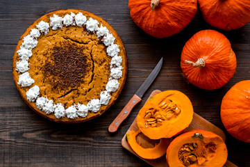 Pumpkin pie for thanksgiving day on dark wooden background top view